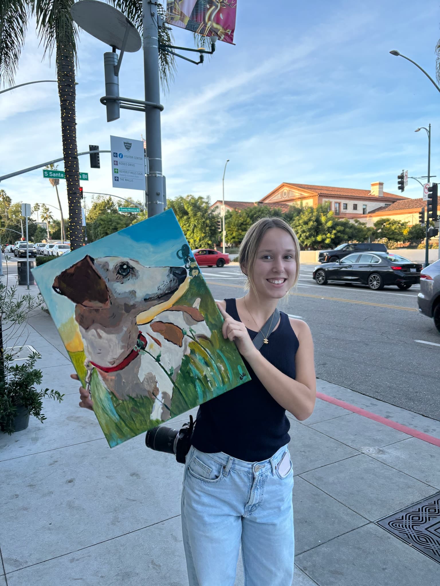 Client outdoors holding a finished commissioned dog portrait