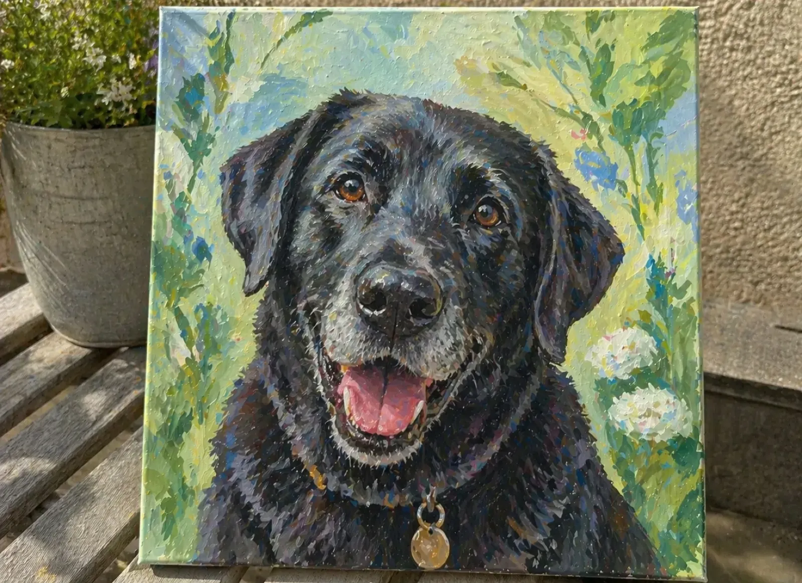 Painted oil portrait of a black labrador retriever with a green floral background