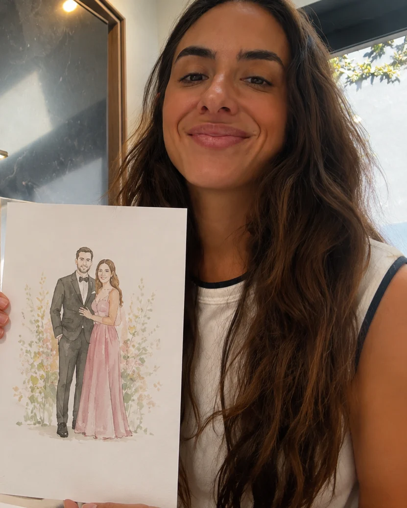 Elena Marmol holding a finished live watercolor guest portrait of a couple in a grey suit and pink gown at an event